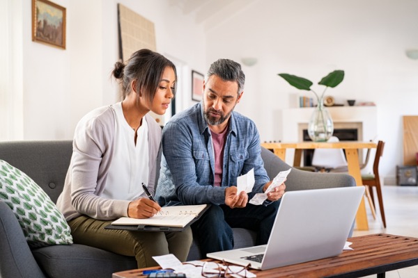 Couple Sitting on couch going over papers